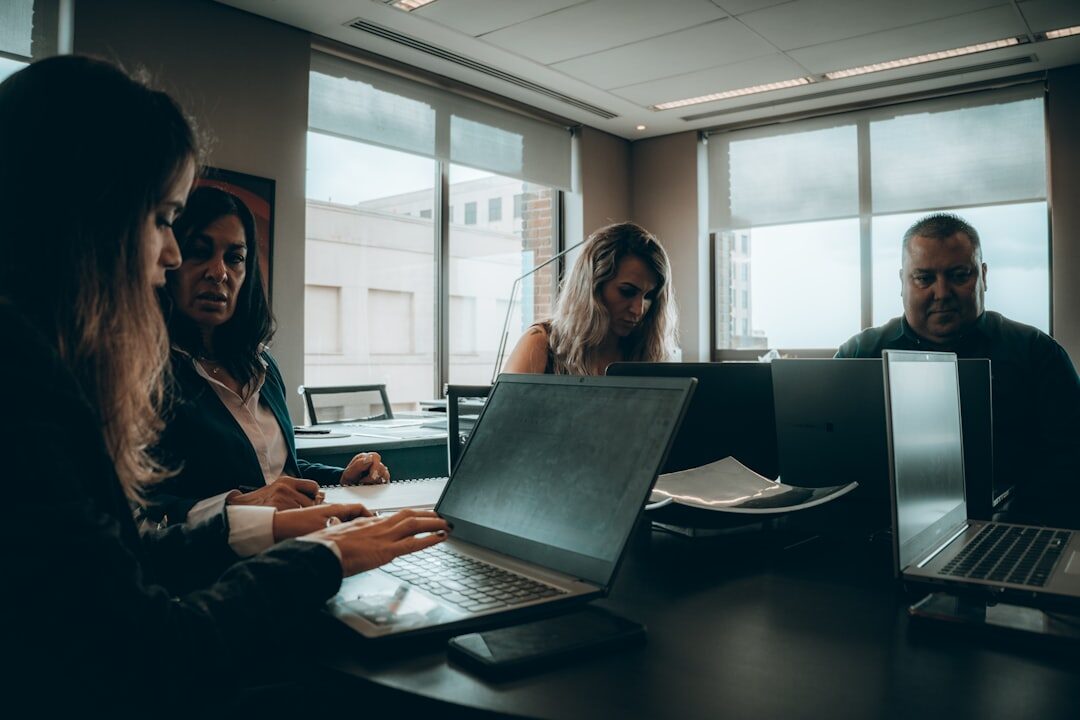 Editorial team gathered around a desk reviewing a run sheet
